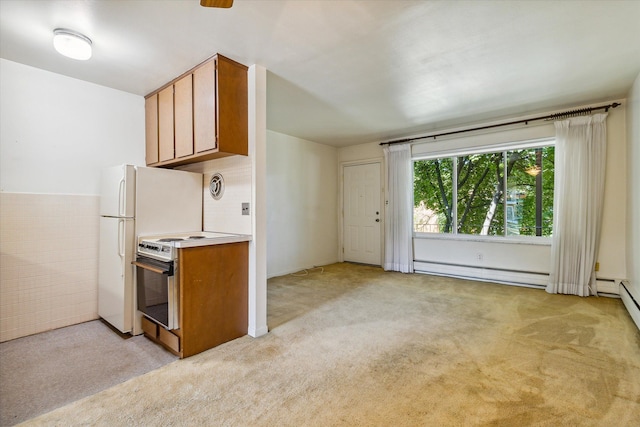 kitchen with white electric range oven, baseboard heating, and light carpet