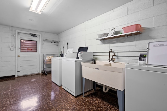 clothes washing area with sink and washing machine and clothes dryer