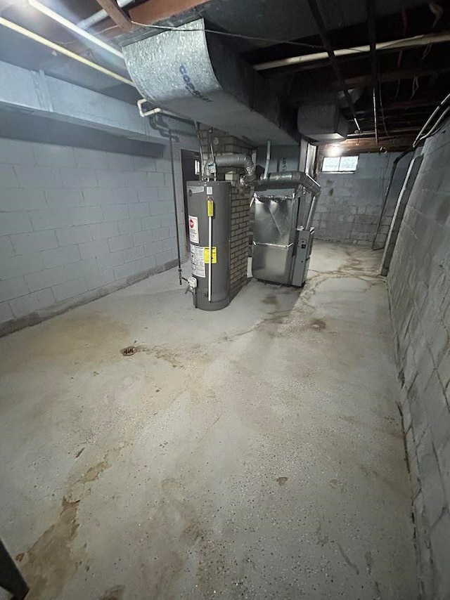 basement featuring gas water heater and heating unit