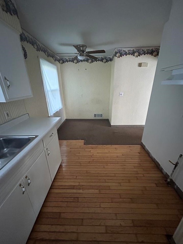 kitchen with white cabinetry, dark hardwood / wood-style flooring, and ceiling fan