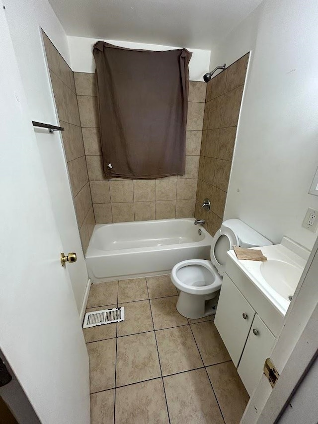 full bathroom featuring tile patterned flooring, vanity, toilet, and tiled shower / bath