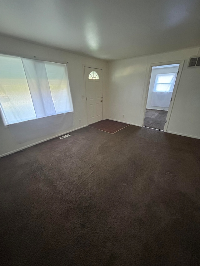 foyer with dark carpet