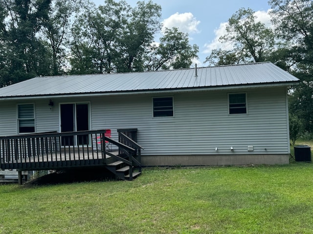 rear view of house with a lawn, central air condition unit, and a wooden deck