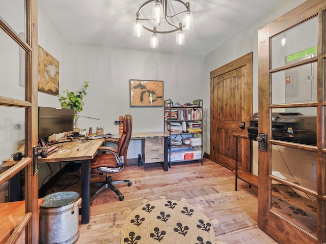 home office with a notable chandelier and light wood-type flooring