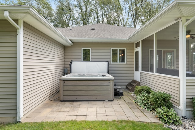 view of patio with a sunroom and a hot tub