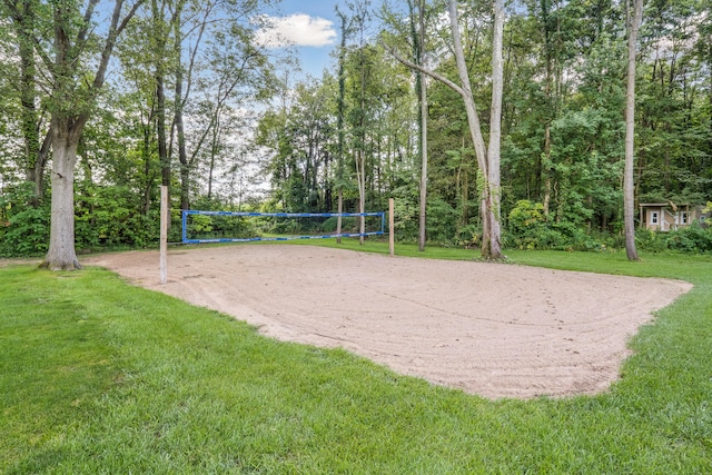 surrounding community with volleyball court and a lawn