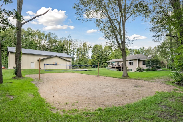 view of home's community with volleyball court and a lawn