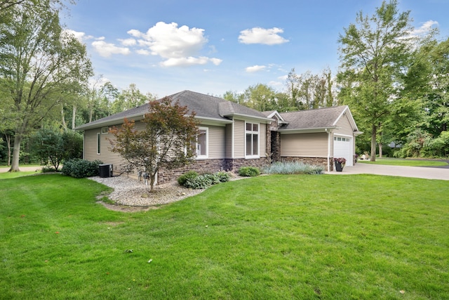 ranch-style house with cooling unit, a front yard, and a garage