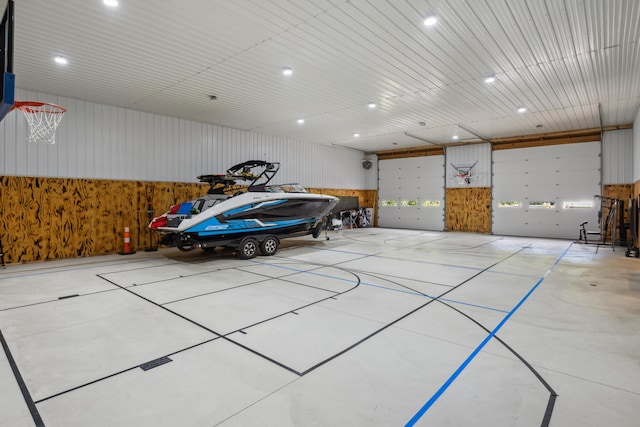 garage featuring wood walls