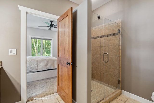 bathroom featuring tile patterned floors, ceiling fan, and a shower with door