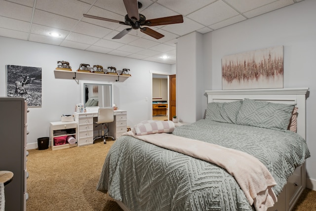 carpeted bedroom featuring a paneled ceiling and ceiling fan