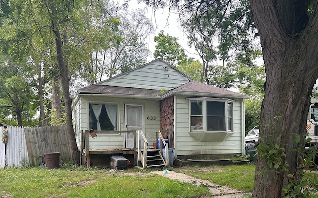 bungalow-style home featuring a front yard