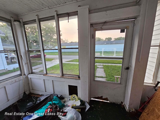 sunroom with plenty of natural light and a water view