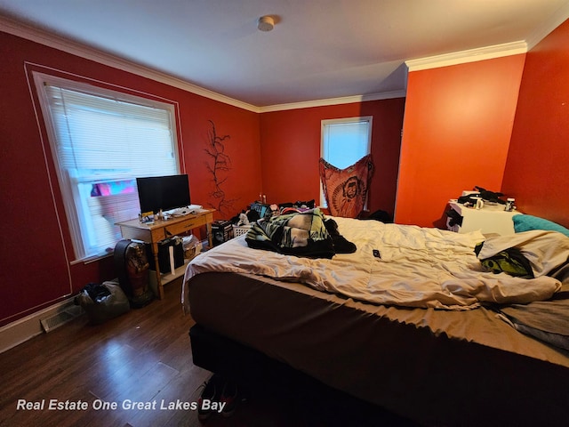 bedroom featuring ornamental molding and dark wood-type flooring