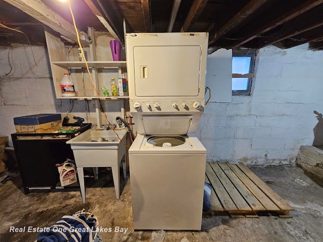 laundry area featuring stacked washer / drying machine