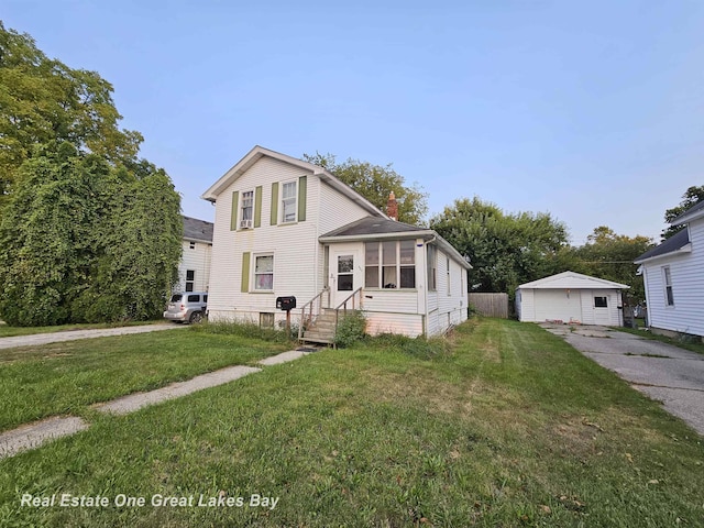 422 N Woodbridge St, Saginaw, MI 48602 - view of front of home with entry steps, a chimney, and a front lawn