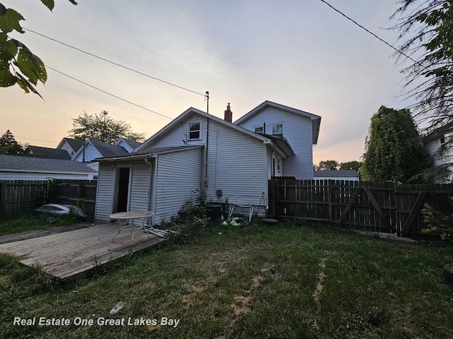 422 N Woodbridge St, Saginaw, MI 48602 - back of house with a wooden deck and a chimney