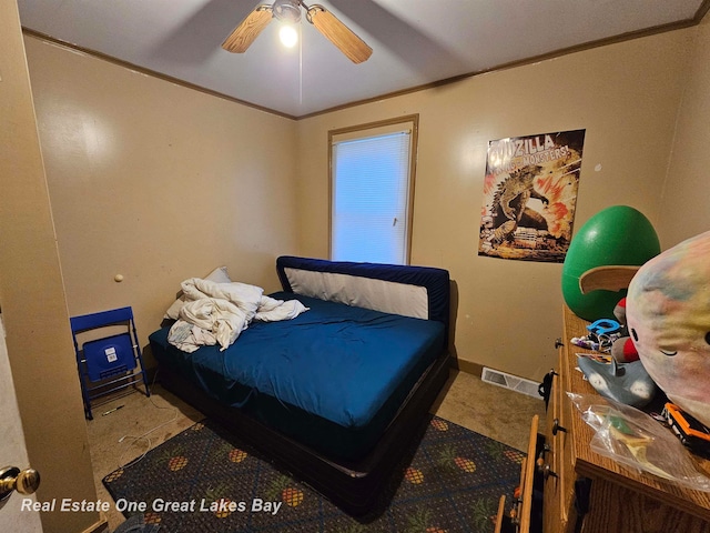 bedroom with ceiling fan, light colored carpet, and ornamental molding