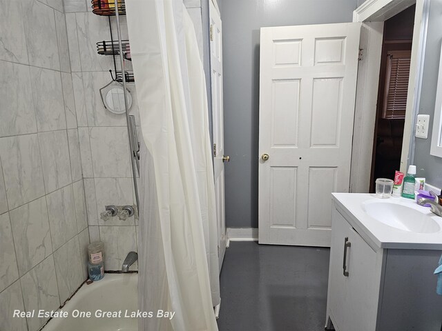 422 N Woodbridge St, Saginaw, MI 48602 - bathroom with vanity, shower / bath combo, and concrete flooring