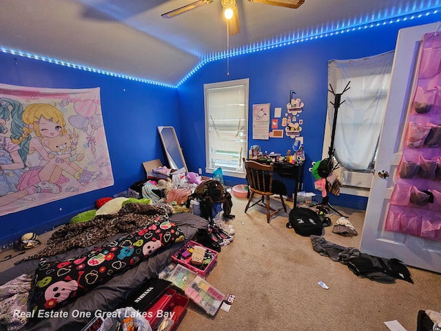 carpeted bedroom with vaulted ceiling and ceiling fan