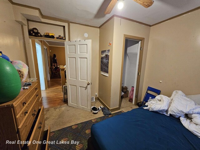 422 N Woodbridge St, Saginaw, MI 48602 - bedroom with crown molding, light colored carpet, baseboards, and a ceiling fan