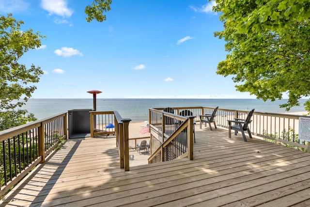 view of dock with a deck with water view