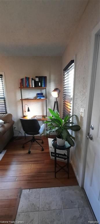 home office with hardwood / wood-style flooring