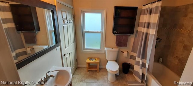 bathroom featuring toilet and shower / tub combo with curtain