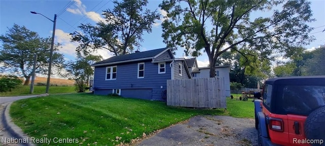 view of property exterior with a yard