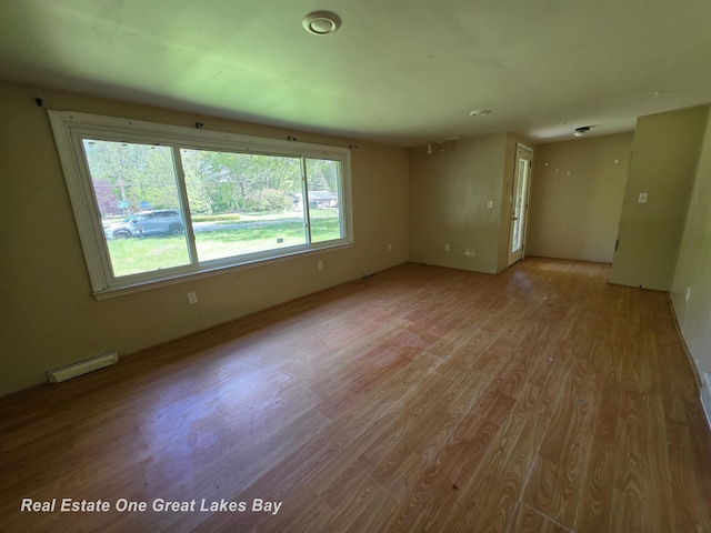 3810 Nicol Dr, Saginaw, MI 48601 - empty room with a baseboard radiator and wood finished floors