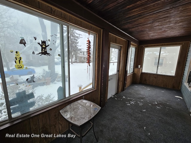 unfurnished sunroom featuring wood ceiling