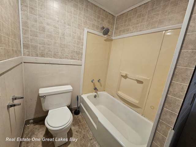 bathroom with shower / tub combination, toilet, ornamental molding, and tile walls