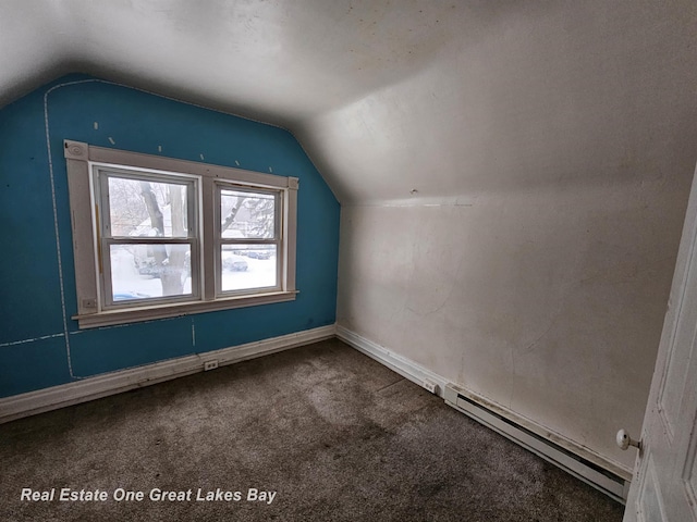 additional living space featuring carpet floors, a baseboard heating unit, and lofted ceiling