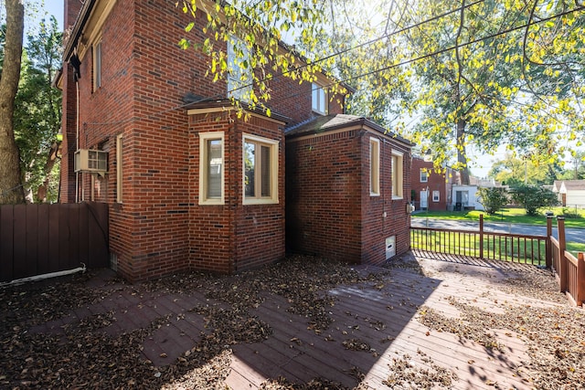 view of property exterior with a wooden deck