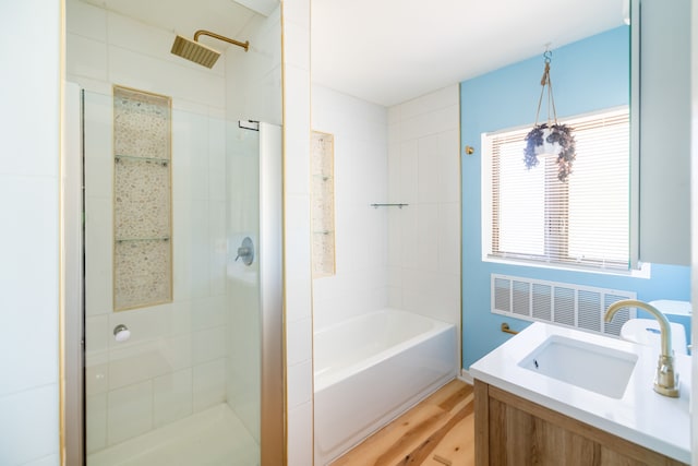 bathroom featuring wood-type flooring, vanity, and independent shower and bath