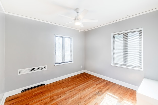 unfurnished room with crown molding, hardwood / wood-style floors, and ceiling fan