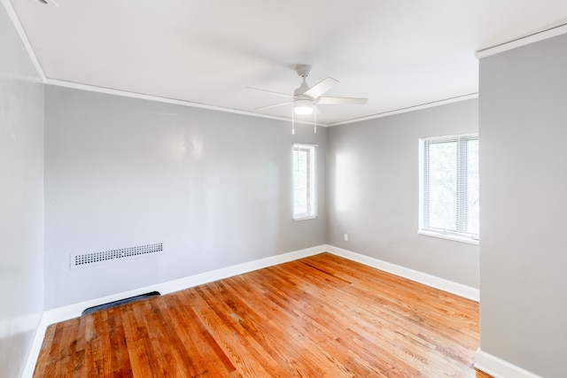 empty room with light hardwood / wood-style flooring, plenty of natural light, ornamental molding, and ceiling fan