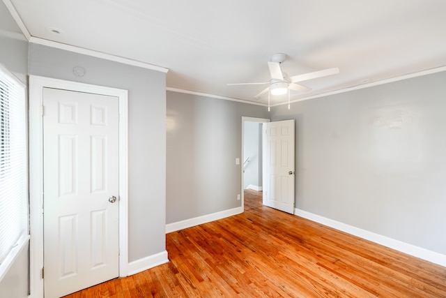 unfurnished room featuring hardwood / wood-style flooring, ceiling fan, and ornamental molding