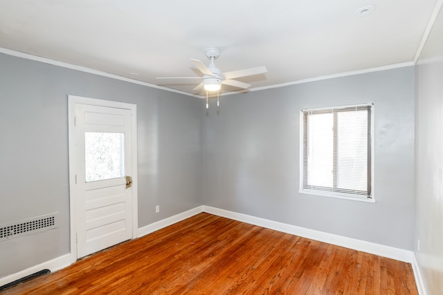 spare room with hardwood / wood-style flooring, ceiling fan, and ornamental molding