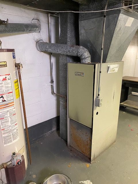 utility room featuring water heater