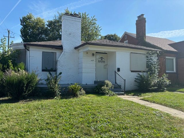 10270 Beaconsfield St, Detroit, MI 48224 - view of front of home featuring a chimney, brick siding, and a front lawn