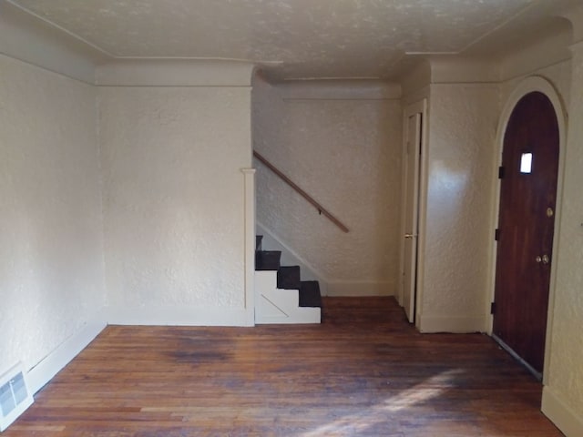 foyer entrance featuring wood-type flooring