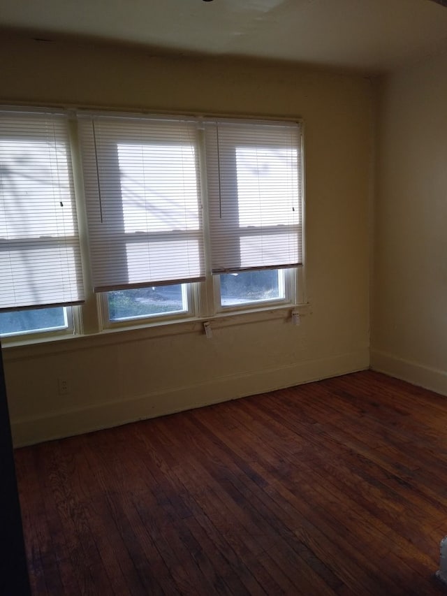 empty room with dark wood-type flooring