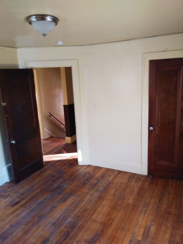 empty room with dark hardwood / wood-style floors