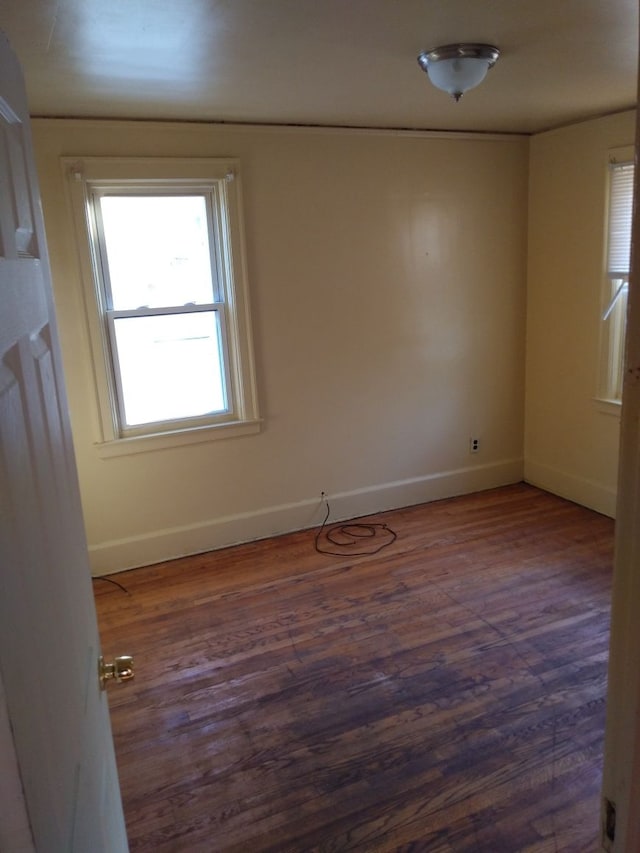 unfurnished room featuring dark hardwood / wood-style flooring