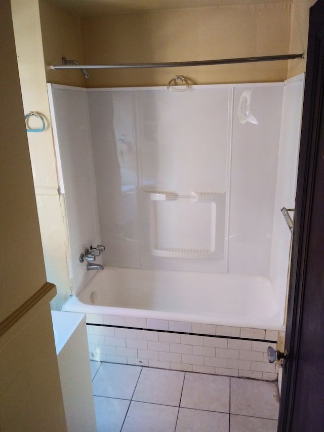 bathroom with tile patterned flooring and tiled shower / bath