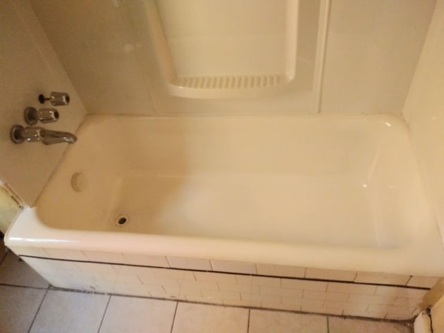 bathroom featuring tile patterned floors and tiled bath