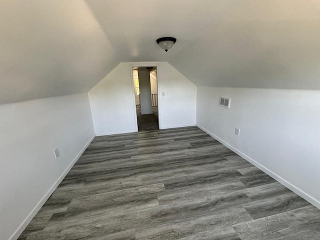 bonus room with dark hardwood / wood-style floors and lofted ceiling