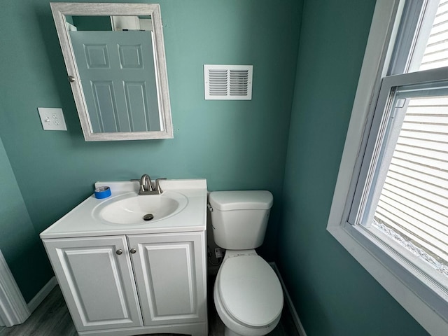 bathroom featuring vanity and toilet