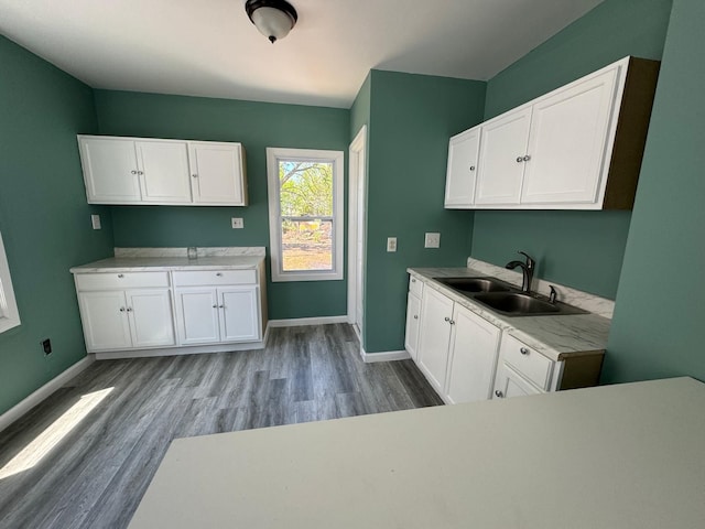 kitchen featuring sink, white cabinets, and light wood-type flooring